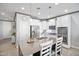 Bright, modern kitchen with white cabinets, stainless steel appliances, and a large island at 20426 N Blazing Sun Rd, Maricopa, AZ 85138