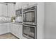 Gourmet kitchen featuring stainless steel appliances, double ovens, and sleek countertops at 20426 N Blazing Sun Rd, Maricopa, AZ 85138