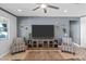 Comfortable living room with a large screen television, stylish furniture and neutral tones at 20426 N Blazing Sun Rd, Maricopa, AZ 85138
