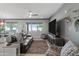 Open living room with a sofa, ceiling fan, media center and lots of natural light at 20426 N Blazing Sun Rd, Maricopa, AZ 85138
