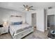 A serene main bedroom features a ceiling fan, a walk-in shower, and neutral decor with ample space at 20426 N Blazing Sun Rd, Maricopa, AZ 85138