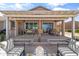 Luxurious outdoor living space with a built-in grill, bar, and comfortable seating under a pergola at 20426 N Blazing Sun Rd, Maricopa, AZ 85138