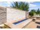 Outdoor space featuring a modern water feature with blue fire glass and decorative stone at 20426 N Blazing Sun Rd, Maricopa, AZ 85138