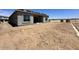 View of the new home construction, showcasing a spacious backyard and covered patio at 22709 E Saddle Way, Queen Creek, AZ 85142
