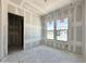 Bedroom view of new construction with drywall, framing, and two windows at 22709 E Saddle Way, Queen Creek, AZ 85142