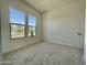 Bright bedroom with carpeted flooring and two large windows offers great light at 22709 E Saddle Way, Queen Creek, AZ 85142