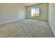 Simple bedroom with a neutral carpet and a window providing ample natural light at 22709 E Saddle Way, Queen Creek, AZ 85142