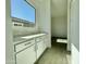 Bright butler's pantry with ample counter space and plenty of cabinets for storage, adding elegance and functionality at 22709 E Saddle Way, Queen Creek, AZ 85142