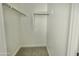 Walk-in closet with ample hanging space and carpeted floor at 22709 E Saddle Way, Queen Creek, AZ 85142