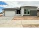 Newly constructed home with a neutral color palette, attached two-car garage, and tidy landscaping at 22709 E Saddle Way, Queen Creek, AZ 85142