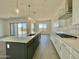 Modern kitchen boasts an island with bar seating and stainless steel appliances at 22709 E Saddle Way, Queen Creek, AZ 85142