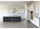 A kitchen features white cabinets and quartz countertops, complete with an island with seating and stainless pendant lighting at 22709 E Saddle Way, Queen Creek, AZ 85142