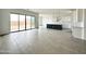 Open-concept living area flows into a sleek kitchen, offering ample natural light and stylish design at 22709 E Saddle Way, Queen Creek, AZ 85142