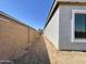 A functional side yard with potential for landscaping, enclosed by a tall block wall for privacy at 22709 E Saddle Way, Queen Creek, AZ 85142