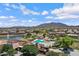 Gorgeous aerial view of a community showcasing a pool, lake, and recreation area with mountain views at 2496 E Lindrick Dr, Gilbert, AZ 85298