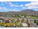 Expansive aerial view of the community featuring a lake, park, and mountain views in the background at 2496 E Lindrick Dr, Gilbert, AZ 85298