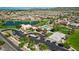 Stunning aerial view of the community with a pool, clubhouse, lake, and mountain views at 2496 E Lindrick Dr, Gilbert, AZ 85298