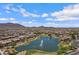 Stunning aerial view showcasing the community lake with fountains and the surrounding mountain landscape at 2496 E Lindrick Dr, Gilbert, AZ 85298