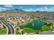 Expansive aerial view showcasing the community layout, homes, lake, and the distant mountain range in the background at 2496 E Lindrick Dr, Gilbert, AZ 85298