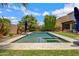 Stunning backyard featuring an in-ground pool with jacuzzi and lush landscaping and lawn at 2496 E Lindrick Dr, Gilbert, AZ 85298