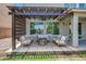 Covered patio with a stone fire pit surrounded by comfortable seating perfect for outdoor relaxation at 2496 E Lindrick Dr, Gilbert, AZ 85298