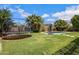 Lush backyard featuring a large trampoline, an in-ground pool, and tasteful landscaping at 2496 E Lindrick Dr, Gilbert, AZ 85298