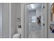 Bathroom area featuring a toilet, a storage shelf, and a sink inside the laundry area with a window at 2496 E Lindrick Dr, Gilbert, AZ 85298