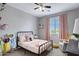 Cozy bedroom featuring a window with natural light, an accent chair and carpeted floors at 2496 E Lindrick Dr, Gilbert, AZ 85298