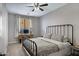 Tranquil bedroom with neutral walls, carpet, a comfortable bed, and a functional desk area for work or study at 2496 E Lindrick Dr, Gilbert, AZ 85298