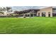 Community clubhouse with large windows, well manicured lawns and patio at 2496 E Lindrick Dr, Gilbert, AZ 85298