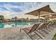 Community pool with sunshades and lounge chairs at 2496 E Lindrick Dr, Gilbert, AZ 85298