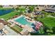 Aerial view of a community pool with lounge chairs and playground at 2496 E Lindrick Dr, Gilbert, AZ 85298