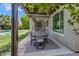 Inviting covered patio featuring an outdoor dining area with backyard and pool views at 2496 E Lindrick Dr, Gilbert, AZ 85298