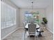 Elegant dining room with a stylish table, chandelier lighting, neutral colors, and lots of natural light at 2496 E Lindrick Dr, Gilbert, AZ 85298