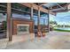 Outdoor fireplace on a covered patio with views of the community lake and fountain at 2496 E Lindrick Dr, Gilbert, AZ 85298