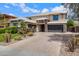 Beautiful house with a well-maintained lawn, paver driveway, and three-car garage showcasing its exterior at 2496 E Lindrick Dr, Gilbert, AZ 85298