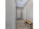 Hallway featuring neutral walls, tile flooring, and stylish storage for an inviting and organized space at 2496 E Lindrick Dr, Gilbert, AZ 85298