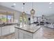 Open kitchen with granite counters, white cabinets, and views of the backyard patio and pool at 2496 E Lindrick Dr, Gilbert, AZ 85298