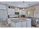 Modern kitchen with granite countertops, stainless steel appliances, and stylish pendant lighting at 2496 E Lindrick Dr, Gilbert, AZ 85298