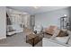 Spacious living room featuring neutral walls, plush carpet, and stylish seating arrangement with modern decor at 2496 E Lindrick Dr, Gilbert, AZ 85298