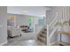 Elegant living room view from the entry featuring neutral tones and a staircase at 2496 E Lindrick Dr, Gilbert, AZ 85298