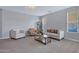 Cozy living room featuring neutral colors, plush carpet, and stylish seating arrangement for relaxing and entertaining at 2496 E Lindrick Dr, Gilbert, AZ 85298
