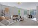 Spacious living area with large windows, comfortable seating, and open access to the dining area at 2496 E Lindrick Dr, Gilbert, AZ 85298