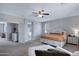Spacious main bedroom with a ceiling fan, ensuite bathroom access, and a large walk-in closet at 2496 E Lindrick Dr, Gilbert, AZ 85298
