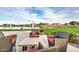 Outdoor seating area with patio furniture overlooking the community lake and fountains at 2496 E Lindrick Dr, Gilbert, AZ 85298