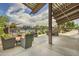 A covered patio area featuring comfortable outdoor seating, offering a perfect spot for relaxation and socializing at 2496 E Lindrick Dr, Gilbert, AZ 85298