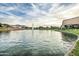 Scenic community pond with fountain and lush green landscaping; a beautiful place to relax at 2496 E Lindrick Dr, Gilbert, AZ 85298