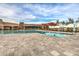 Resort style community swimming pool and lounge area with shade canopies and comfortable lounge chairs for relaxing at 2496 E Lindrick Dr, Gilbert, AZ 85298