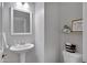 Charming powder room featuring a pedestal sink, toilet, decor, and decorative wall art for a touch of character at 2496 E Lindrick Dr, Gilbert, AZ 85298