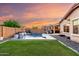 Beautiful backyard featuring a sparkling pool with waterfall, manicured lawn, and ample space for outdoor enjoyment at 2607 W Gray Wolf Trl, Phoenix, AZ 85085